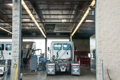 A backside view of a semi truck parked in the service shop at Fresno Truck Center