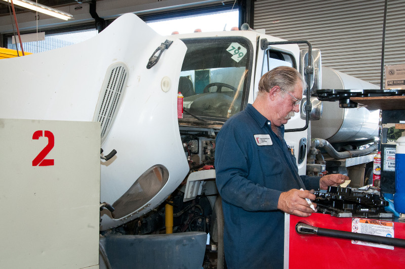 A middle aged man plans his next move in the service shop at Bakersfield Truck Center